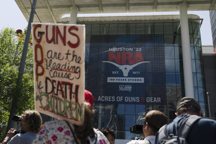 ASSOCIATED PRESS
                                People gather outside the George R. Brown Convention Center to protest the National Rifle Association’s annual meeting in Houston.