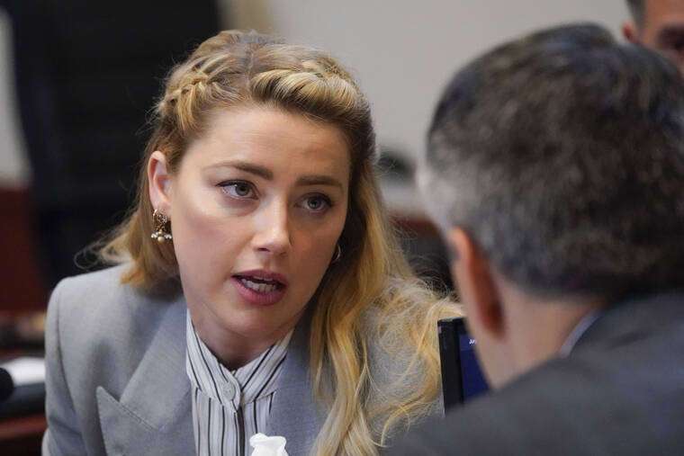 ASSOCIATED PRESS
                                Actor Amber Heard speaks to her legal team in the courtroom at the Fairfax County Circuit Courthouse in Fairfax, Va. Actor Johnny Depp sued his ex-wife Amber Heard for libel in Fairfax County Circuit Court after she wrote an op-ed piece in The Washington Post in 2018 referring to herself as a “public figure representing domestic abuse.”