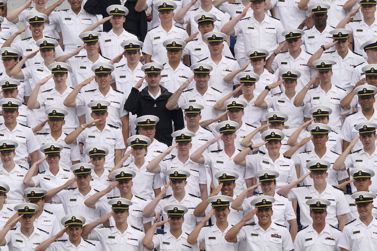 ASSOCIATED PRESS
                                Undergraduate midshipmen salute as they watch the U.S. Naval Academy’s graduation and commissioning ceremony at the Navy-Marine Corps Memorial Stadium in Annapolis, Md.