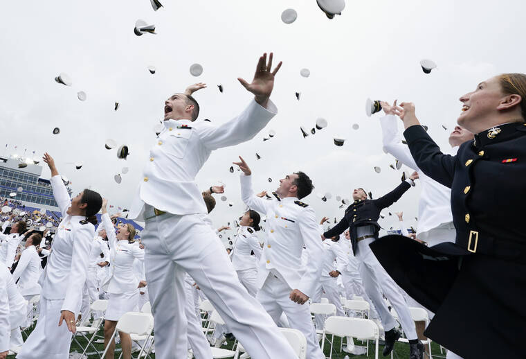 ASSOCIATED PRESS
                                U.S. Naval Academy graduates celebrate and throw their covers at the end of the academy’s graduation and commission ceremony in Annapolis, Md.