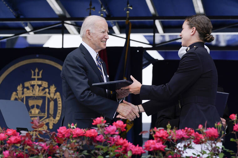 ASSOCIATED PRESS
                                A U.S. Naval Academy graduate is congratulated and receives their diploma from President Joe Biden during the U.S. Naval Academy graduation and commissioning ceremony in Annapolis, Md.