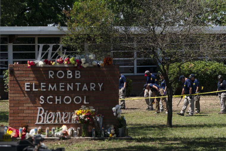 ASSOCIATED PRESS / MAY 25
                                Investigators search for evidences outside Robb Elementary School in Uvalde, Texas. The children who survived the attack, which killed 19 schoolchildren and two teachers, described a festive, end-of-the-school-year day that quickly turned to terror.