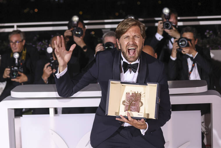 INVISION / AP
                                Writer/director Ruben Ostlund, winner of the Palme d’Or for ‘Triangle of Sadness,’ poses for photographers during the photo call following the awards ceremony at the 75th international film festival, Cannes, southern France, Saturday.