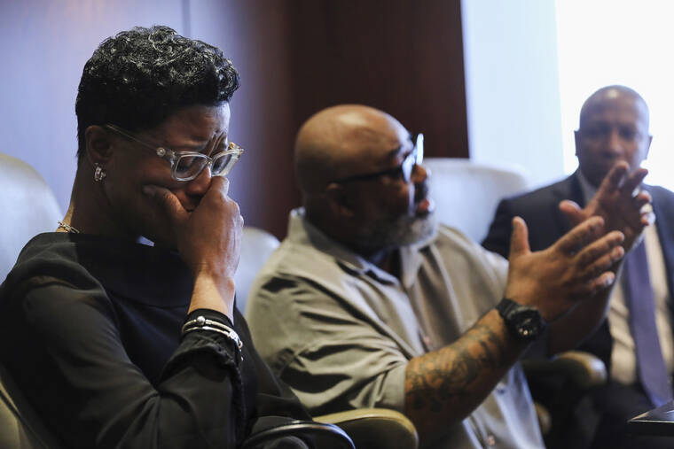 CHICAGO TRIBUNE / AP
                                Veldarin Jackson, Sr., center, talks about receiving the call that his mother, Janice Reed, had died as his wife Adjoa Jackson, left, becomes emotional, Tuesday, in Chicago. Reed was one of the three senior victims who died in a Rogers Park building where residents complained of heat.