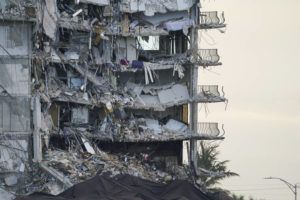 ASSOCIATED PRESS / JULY 4
                                A giant tarp covers a section of rubble where search and rescue personnel have been working at the Champlain Towers South condo building in Surfside, Fla.