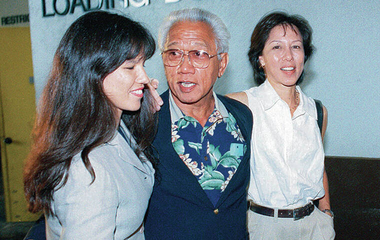 STAR-ADVERTISER / 1999
                                Bishop Estate trustee Richard Wong leaves District Court with his daughters.
