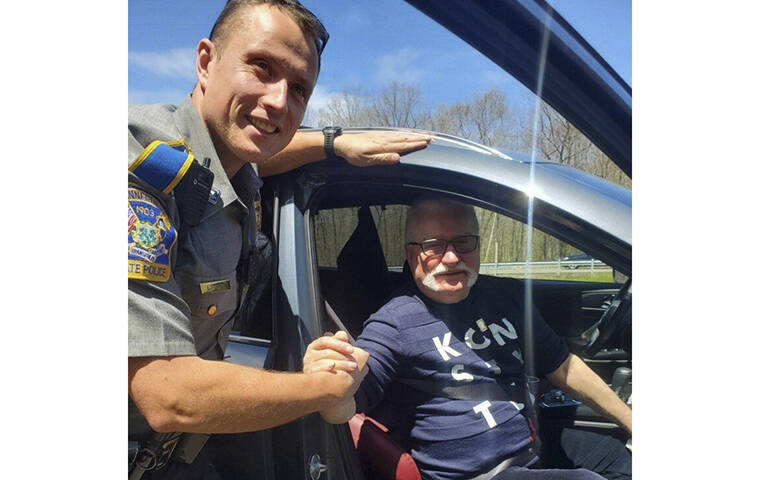 CONNECTICUT STATE POLICE / AP
                                Trooper Lukasz Lipert shakes hands with former Polish President Lech Walesa on Interstate 84 in Tolland, Conn.