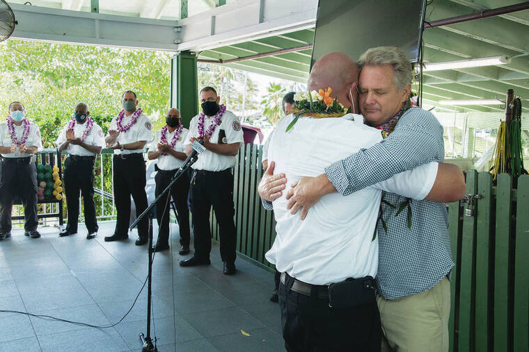 CRAIG T. KOJIMA / CKOJIMA@STARADVERTISER.COM 
                                Norm Skorge, above right, thanked EMS paramedic Mitch Kam for saving his life at a ceremony Sunday at the Oahu Club. The event kicked off National Emergency Medical Services Week.