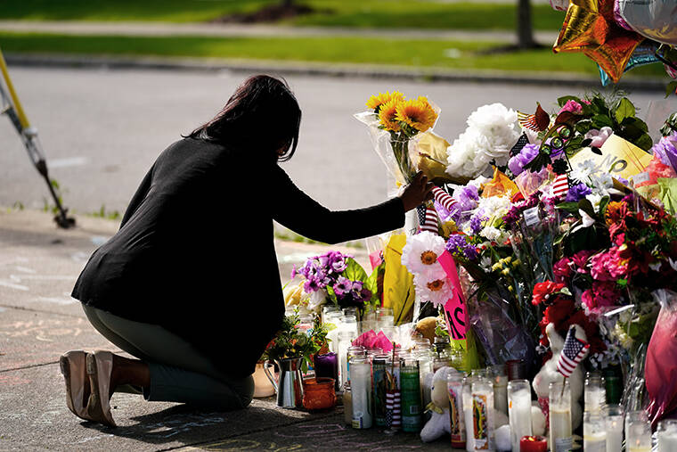 MATT ROURKE / AP
                                Shannon Waedell-Collins pays her respects at the scene of Saturday’s shooting at a supermarket, in Buffalo, N.Y.
