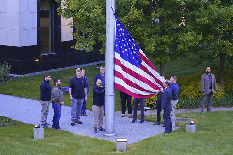 EFREM LUKATSKY / AP
                                Employees of US embassy in Ukraine raise the US national flag at the US embassy, as Russia’s attack on Ukraine continues, in Kyiv, Ukraine.