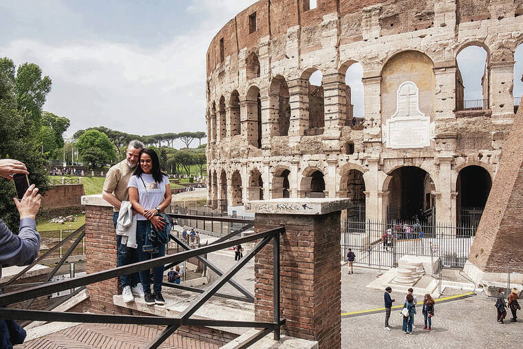 NEW YORK TIMES
                                Sightseers snap a photo at the Colosseum in Rome.
