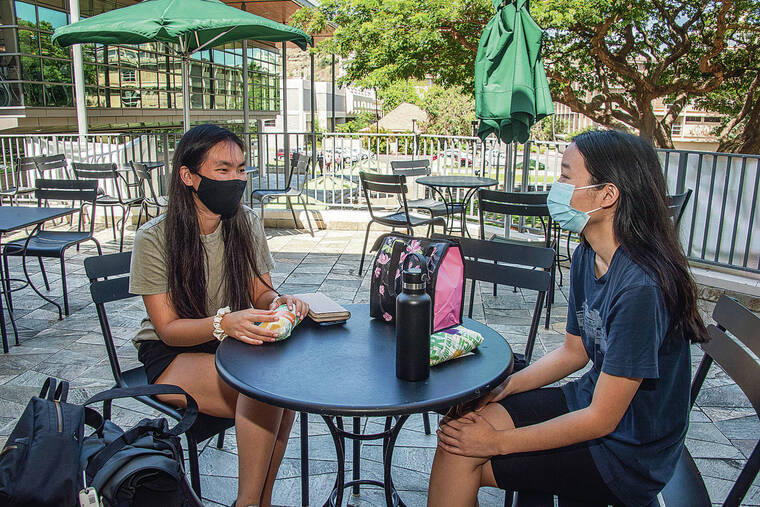 CRAIG T. KOJIMA / CKOJIMA@STARADVERTISER.COM
                                Kylie Kawamura, left and Danielle Arakaki wore masks Tuesday on the University of Hawaii at Manoa campus, where they are attending summer classes.
