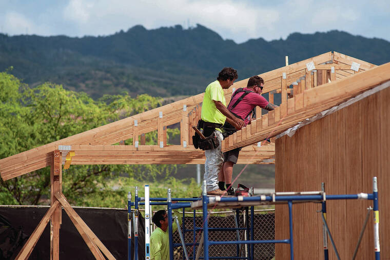 CABLE HOOVER / SPECIAL TO THE STAR-ADVERTISER
                                Builders worked on the roof trusses of a home in Kapolei on Thursday, one of several being built on vacant lots in the Kauluokahai homesteading subdivision.