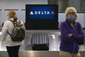 ASSOCIATED PRESS / JULY 12
                                Passengers wait for luggage in the arrival area of Delta Air Lines at Logan International Airport in Boston.