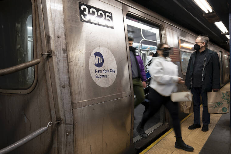 ASSOCIATED PRESS / FEB. 21
                                Passengers disembark a train in the Manhattan subway system in New York. The shooting came shortly before noon on a Q train in Manhattan just before arrival at the Canal Street station, police said.