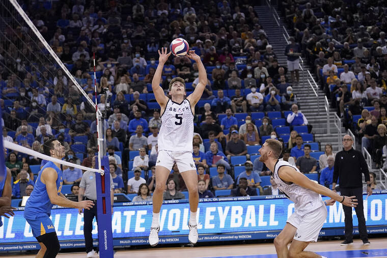ASSOCIATED PRESS
                                Long Beach State setter Aiden Knipe sets the ball on Thursday as his father and coach, Alan, watches from the sideline.