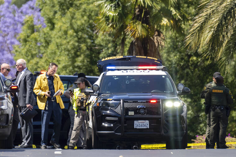 LEONARD ORTIZ, ORANGE COUNTY REGISTER/SCNG VIA AP
                                Orange Sheriff deputies and investigators gather on Calle Sonora after one person died and four people were critically injured in a shooting at a Geneva Presbyterian Church in Laguna Woods.