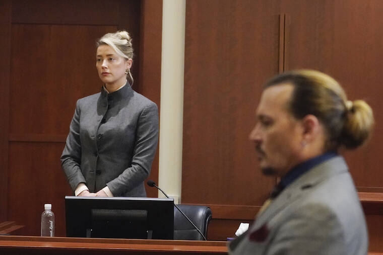 AP PHOTO/STEVE HELBER, POOL
                                Actors Amber Heard and Johnny Depp watch as the jury leaves the courtroom at the end of the day at the Fairfax County Circuit Courthouse in Fairfax, Va. Depp sued his ex-wife Heard for libel in Fairfax County Circuit Court after she wrote an op-ed piece in The Washington Post in 2018 referring to herself as a “public figure representing domestic abuse.”