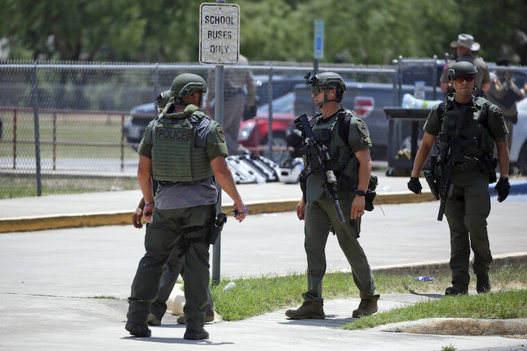 ASSOCIATED PRESS
                                Police stand outside the Robb Elementary school in Uvalde, Texas. A Texas hospital says two people have died after a shooting at an elementary school in Uvalde. Uvalde Memorial Hospital says it received 13 children via ambulance or bus for treatment after an active shooter was reported at Robb Elementary School in Uvalde, about 85 miles west of San Antonio.