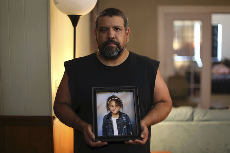 ASSOCIATED PRESS / MAY 26
                                Vincent Salazar holds up a framed photograph of his daughter, Layla Salazar at his home in Uvalde, Texas. Layla Salazar was one of the 19 children and their two teachers who were gunned down behind a barricaded door at Robb Elementary School. Each morning as he drove her to school in his pickup, Salazar would play “Sweet Child O’ Mine,” by Guns N’ Roses and they’d sing along, he said.