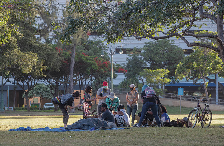 CINDY ELLEN RUSSELL / MARCH 10
                                A team interviews homeless people at Aala Park during the annual <a href="https://www.partnersincareoahu.org/news/2022-point-in-time-count-report-released" target="_blank">Point-in-Time Count</a>. The previous count was in January 2020, before the COVID-19 pandemic shutdown.