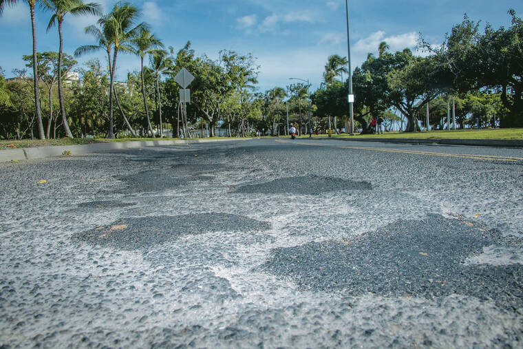 CRAIG T. KOJIMA / CKOJIMA@STARADVERTISER.COM
                                Pothole patches are seen on the heavily used roadway into Waikiki.