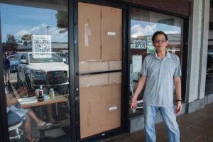 CRAIG T. KOJIMA / CKOJIMA@STARADVERTISER.COM
                                Norman Lee, owner of Jack’s Restaurant, stood Wednesday in front of the damaged entry to the restaurant — one of three in Aina Haina broken into and robbed earlier in the day.