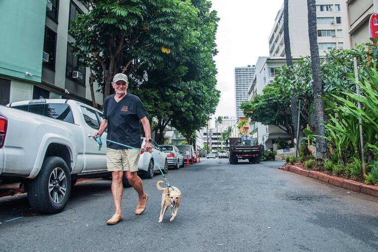 CRAIG T. KOJIMA / CKOJIMA@STARADVERTISER.COM
                                Rolf Nordahl, president of the Waikiki Grand Hotel AOAO, said for years the Chun brothers would allow food trucks to park in the Waikiki Grand’s loading zone on Lemon Road, disrupting the hotel and the residents who live there. Above, Nordahl walks a dog on Lemon Road.