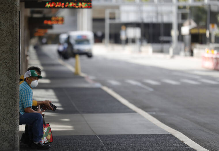 STAR-ADVERTISER / FEBRUARY 2020
                                A man wore a mask while waiting for transportation at the curbside at the Daniel K. Inouye International Airport in Honolulu.