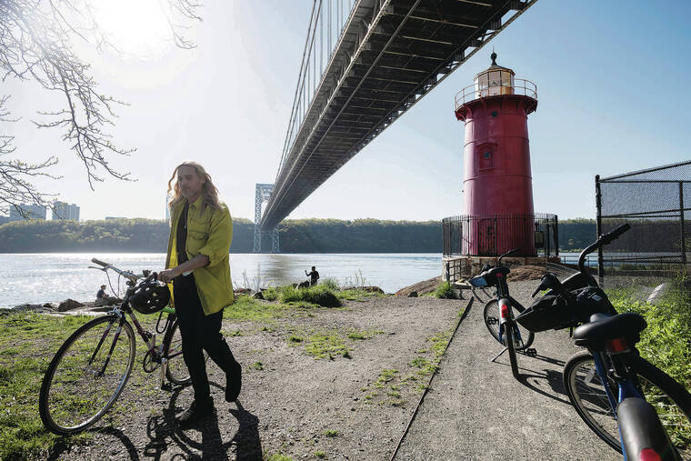 NEW YORK TIMES
                                Cyclists take a break near the Little Red Lighthouse under the George Washington Bridge in New York.