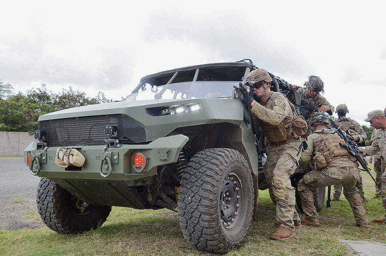 KEVIN KNODELL / KKNODELL@STARADVERTISER.COM
                                Members of the 25th Infantry Division on Wednesday practiced loading a wounded soldier onto a new Infantry Squad Vehicle, designed by General Motors, at Marine Corps Training Area Bellows.