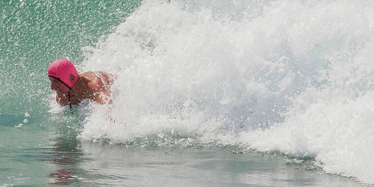 STAR ADVERTISER / 2016 
                                Mark Cunningham, a retired City and County of Honolulu lifeguard and legendary waterman, rides a wave during a bodysurfing contest.