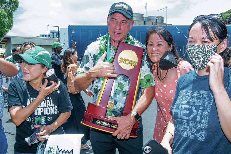 CRAIG T. KOJIMA / CKOJIMA@STARADVERTISER.COM
                                Charlie Wade, University of Hawaii head volleyball coach, held the NCAA trophy and celebrated with fans Sunday after the team’s return to Honolulu.