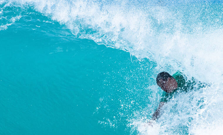 CRAIG T. KOJIMA / CKOJIMA@ STARADVERTISER.COM
                                A bodysurfer catches a wave at Point Panic today.