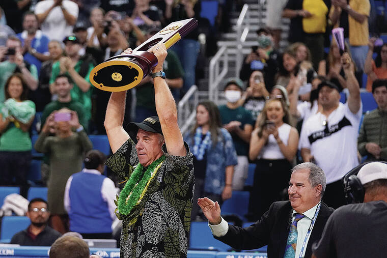 ASSOCIATED PRESS
                                UH coach Charlie Wade held up the NCAA trophy after the Warriors beat the Beach in the final on Saturday.