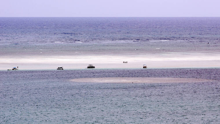 ASSOCIATED PRESS
                                People stand on the sandbar in Kaneohe Bay in August 2015. State law enforcement wants to shut down an illegal, five-boat “Sexy Sandbar Saturday” party being promoted Saturday from Marine Corps Base Hawaii to the Ahu o Laka sandbar in Kaneohe Bay.