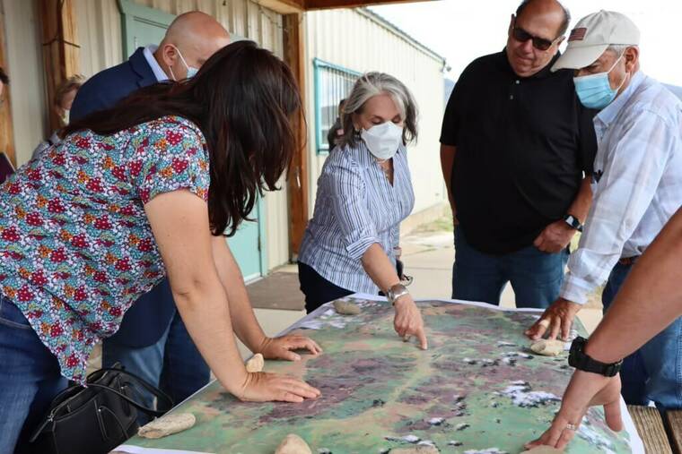 OFFICE OF THE GOVERNOR OF NEW MEXICO / AP
                                New Mexico’s Gov. Michelle Lujan Grisham, middle, meets with local officials as she surveys wildfire damage in Mora County, N.M., Tuesday.