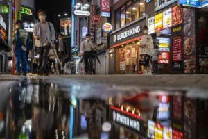ASSOCIATED PRESS
                                People walk along the streets full of bars and restaurants Oct. 1, 2021, in Shibuya, an entertainment district of Tokyo.