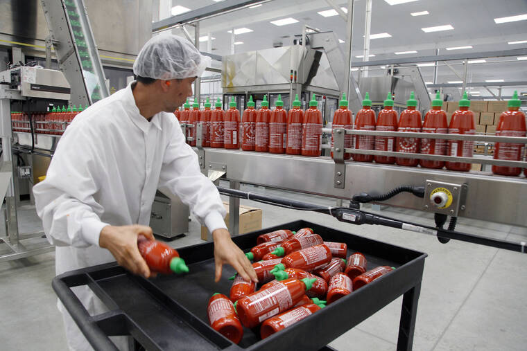 ASSOCIATED PRESS Sriracha chili sauce is produced, in October 2013, at the Huy Fong Foods factory in Irwindale, Calif. Bottles of the popular Sriracha hot sauce could be hard to find on store shelves this summer.