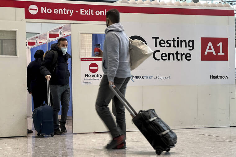 ASSOCIATED PRESS
                                Passengers get a COVID-19 test at Heathrow Airport in London onNov. 29. The Biden administration is lifting its requirement that international air travelers to the U.S. take a COVID-19 test within a day before boarding their flights.