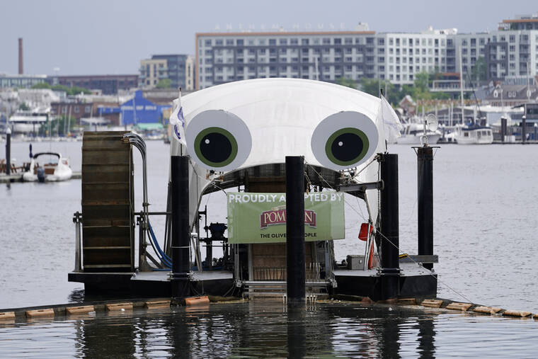 ASSOCIATED PRESS
                                Mr. Trash Wheel, a mechanism that collects trash from tributaries that feed into Baltimore’s Inner Harbor sits in the water, May 13, in Baltimore. Many novel devices are being used or tested worldwide to trap plastic trash in rivers and smaller streams before it can get into the ocean. Officials say Mr. Trash Wheel has inspired fans to begin recycling or join trash cleanups.