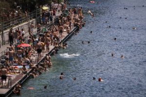 MICHAEL BUHOLZER/KEYSTONE VIA ASSOCIATED PRESS
                                People swim in the river Limmat at Letten, in Zurich, Switzerland, Saturday, June 18, 2022. People flocked to parks and pools across Western Europe, today, for a bit of respite from an early heat wave that saw the mercury rise above 40 Cs (104 F) in France and Spain, and highs of 38 C (100.4 F) in Germany.
