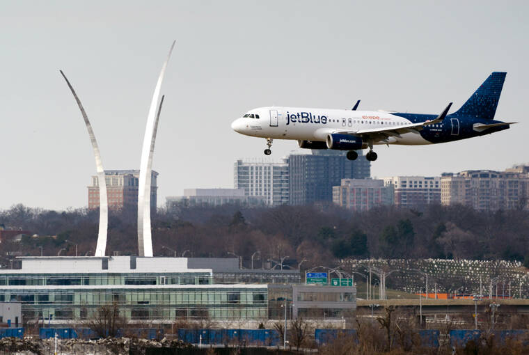 ASSOCIATED PRESS
                                A JetBlue passenger flight lands at Reagan Washington National Airport in Arlington, Va., across the Potomac River from Washington, Jan. 19. On Friday, federal regulators said Verizon and AT&T will delay part of their 5G rollout near airports to give airlines more time to ensure that equipment on their planes is safe from interference from the wireless signals, but the airline industry is not happy about the deal.