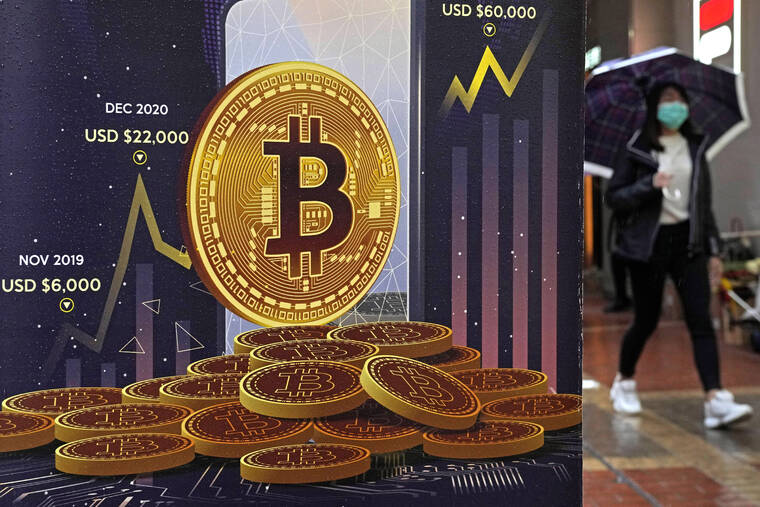 ASSOCIATED PRESS
                                An advertisement for Bitcoin cryptocurrency is displayed on a street in Hong Kong on Feb. 17. The wealth-generating hot streak for bitcoin and other cryptocurrencies has turned brutally cold.