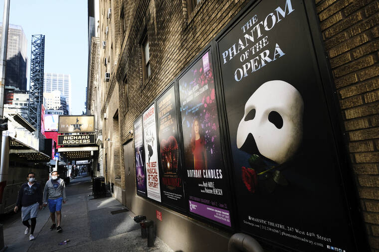 EVAN AGOSTINI/INVISION/ASSOCIATED PRESS
                                Broadway posters appear outside the Richard Rodgers Theatre during the COVID-19 lockdown in New York in May 2020. Broadway theaters will no longer demand audiences wear masks starting in July.