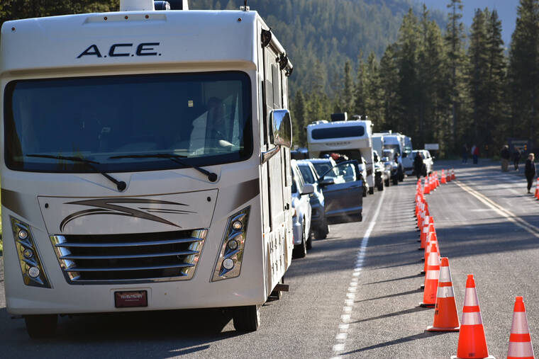 ASSOCIATED PRESS
                                Dozens of vehicles lined up outside Yellowstone National Park’s entrance, today, near Wapiti Wyo. The park is partially reopening after being forced to close last week when record flooding caused widespread damage.