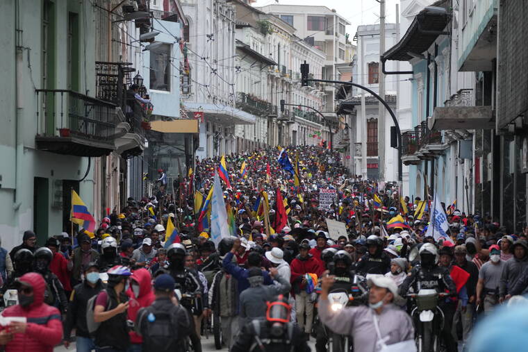 ASSOCIATED PRESS
                                Anti-government protesters march to the presidential palace in Quito, Ecuador, today.