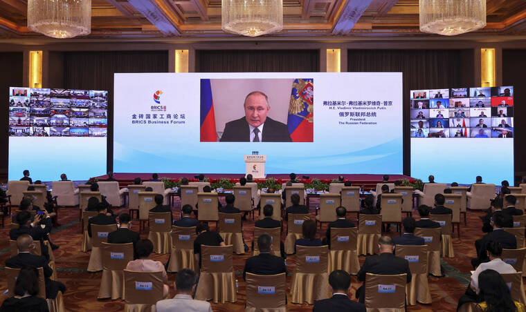 XINHUA VIA AP
                                In this photo released by Xinhua News Agency, Russian President Vladimir Putin delivers a keynote speech in virtual format at the opening ceremony of the BRICS Business Forum in Beijing on Wednesday.