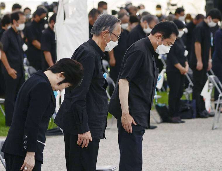 KYODO NEWS VIA AP
                                Japan’s Prime Minister Fumio Kishida, right, offers a silent prayer during a ceremony at the Peace Memorial Park in Itoman, Okinawa, on Thursday.