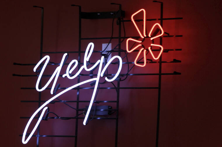 ASSOCIATED PRESS / 2011
                                The logo of the online reviews website Yelp is shown in neon on a wall at the company’s Manhattan offices in New York. Yelp is closing some physical offices, saying employees were hardly using them since the company went remote. Yelp said it’s closing offices in New York, Washington and Chicago and downsizing in Phoenix.